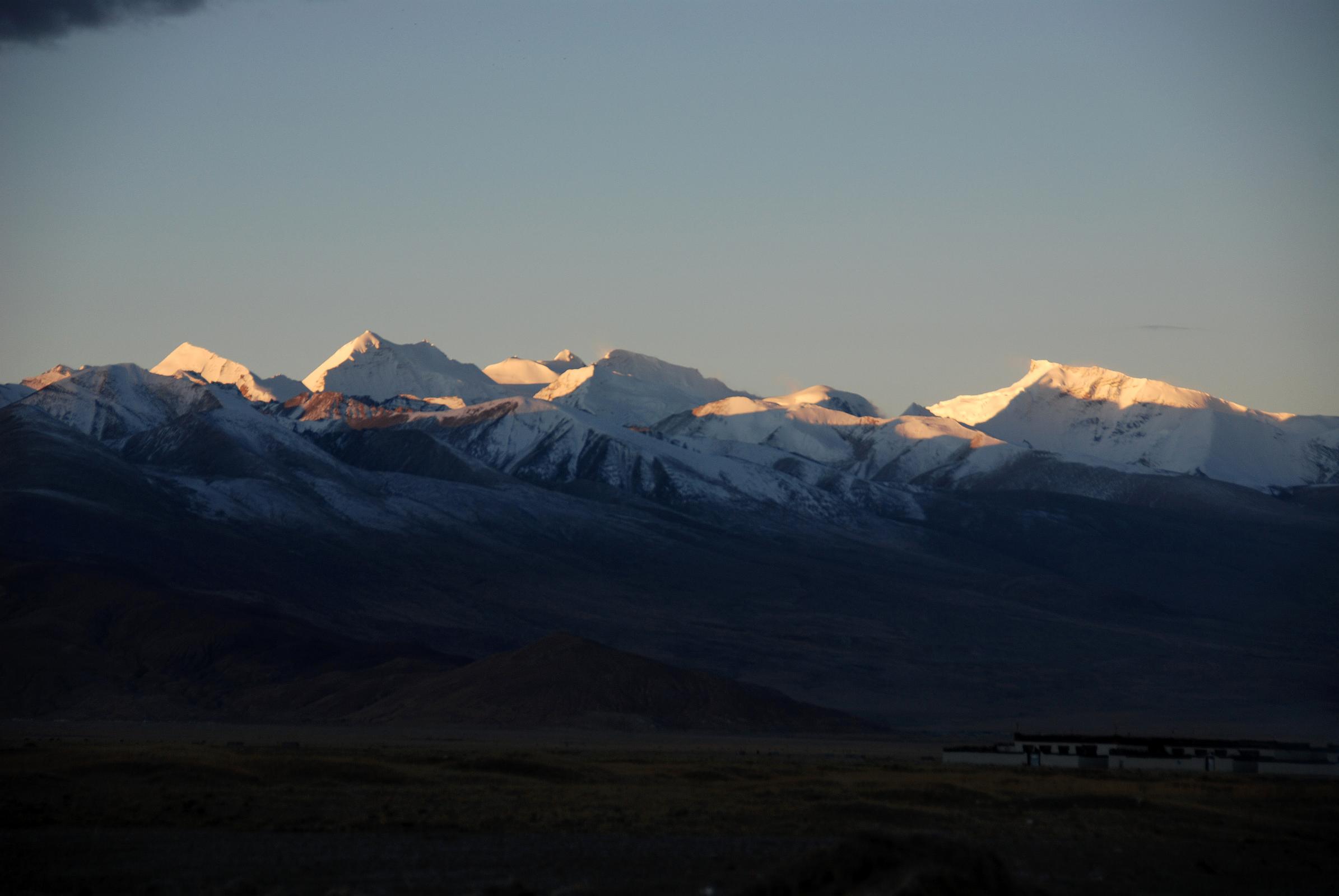 06 Labuche Kang III E and Labuche Kang I At Sunrise From Across Tingri Plain The Labuche Kang massif is part of a beautiful mountain panorama viewed to the southwest from Tingri at sunrise. This massif has several summits over 7000m, including Lobuche Kang III East (7250m) in the centre and Labuche Kang (7367m, also called Lobuche Kang I or Choksiam), the broad partly sunlit mountain on the far right.